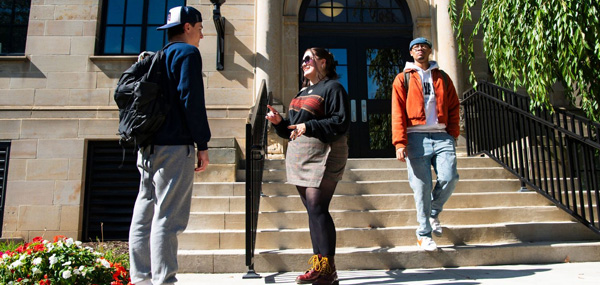 students talking outside building